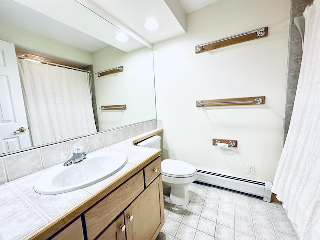 bathroom with a baseboard radiator, vanity, toilet, and tile patterned floors