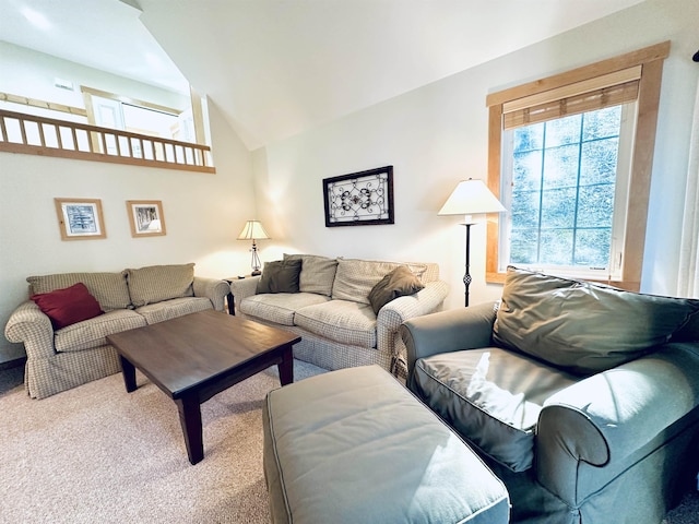 carpeted living room featuring high vaulted ceiling