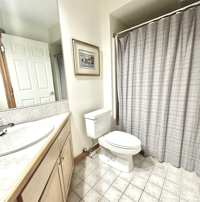 bathroom with tile patterned flooring, vanity, curtained shower, and toilet