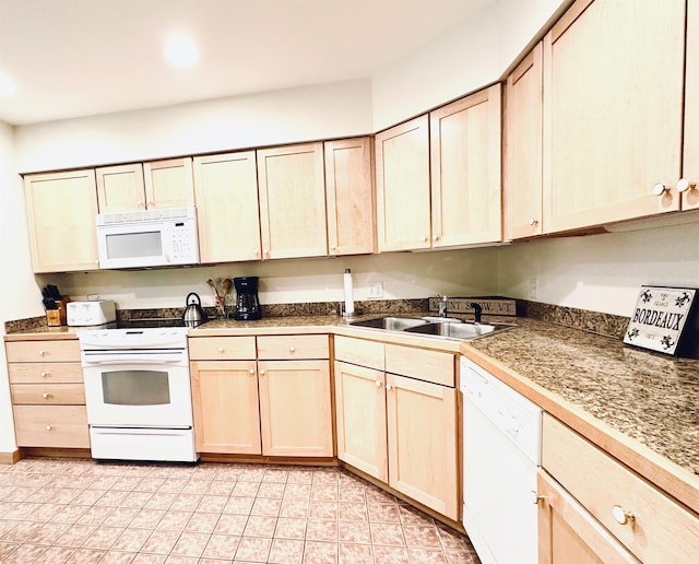 kitchen with sink, white appliances, and light brown cabinets