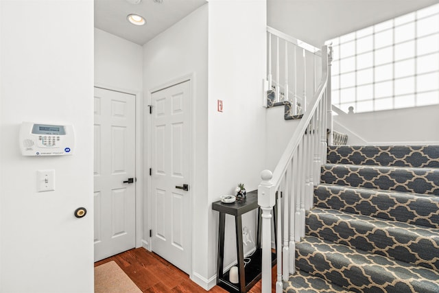 stairs featuring wood-type flooring