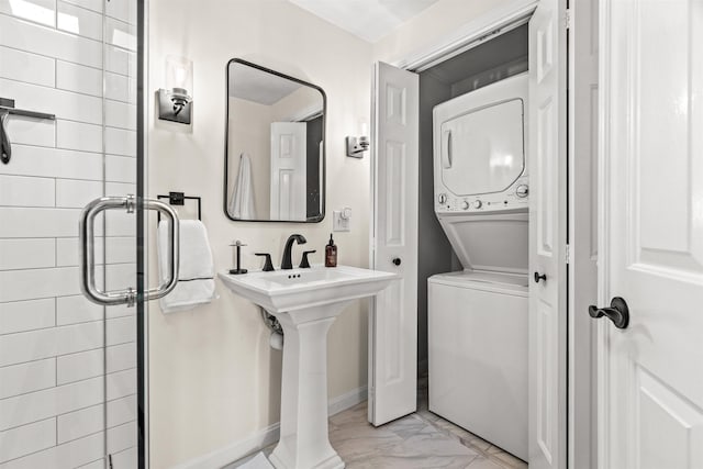 laundry area with stacked washer and dryer