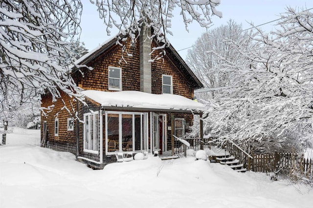 view of snow covered rear of property