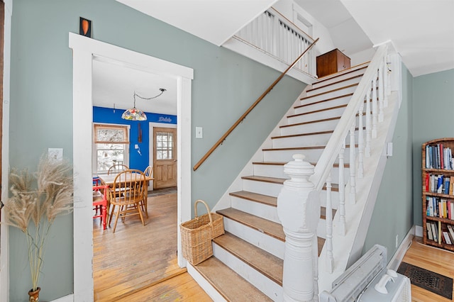 stairs with hardwood / wood-style flooring