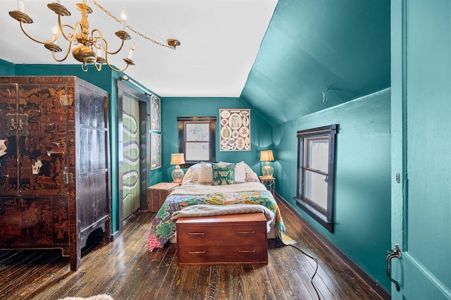 bedroom featuring an inviting chandelier, dark wood-type flooring, and vaulted ceiling