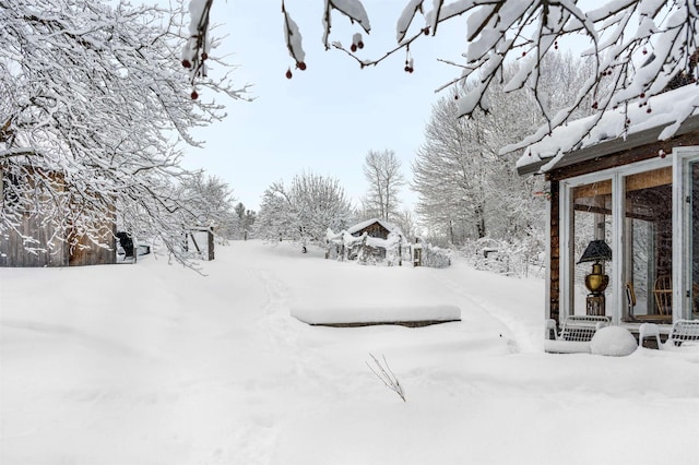 view of yard layered in snow