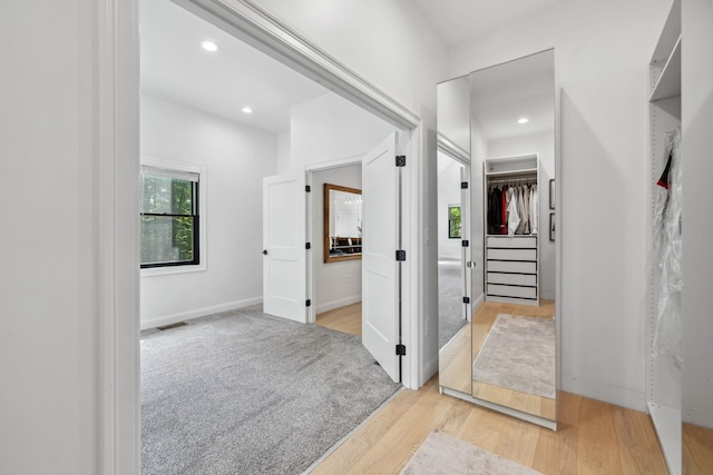 corridor featuring light hardwood / wood-style floors