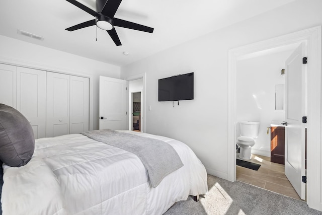 carpeted bedroom with ceiling fan, connected bathroom, and a closet