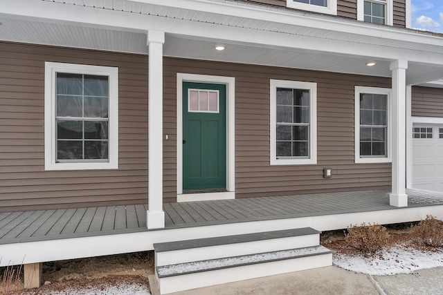 view of exterior entry with a porch