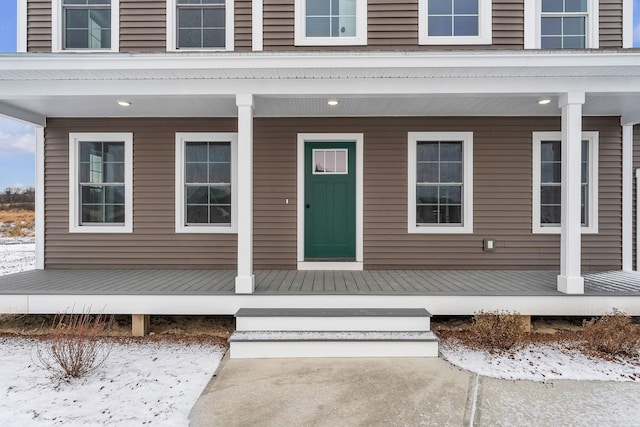 view of snow covered property entrance