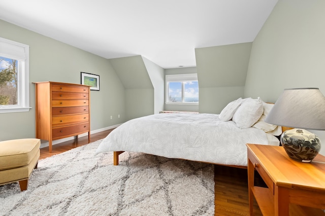 bedroom with lofted ceiling and wood-type flooring