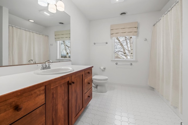 bathroom featuring vanity and toilet