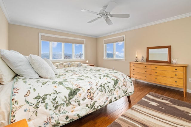 bedroom featuring crown molding, dark hardwood / wood-style flooring, and multiple windows