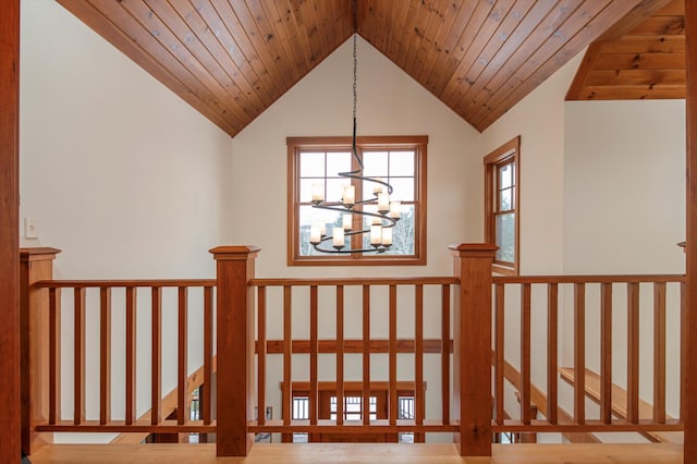 stairway featuring lofted ceiling, wooden ceiling, and an inviting chandelier