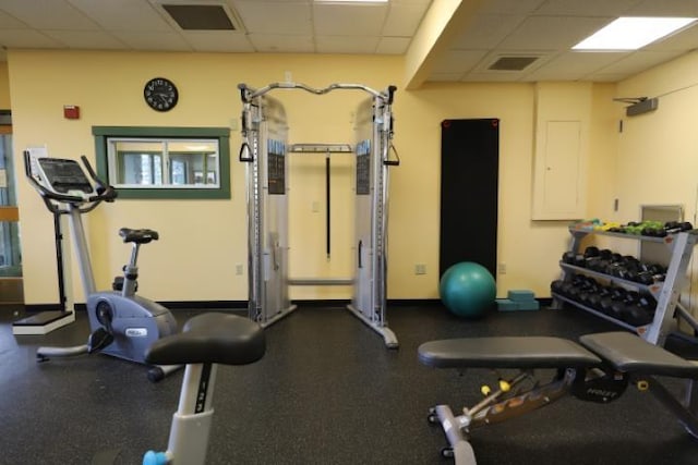 gym with a paneled ceiling