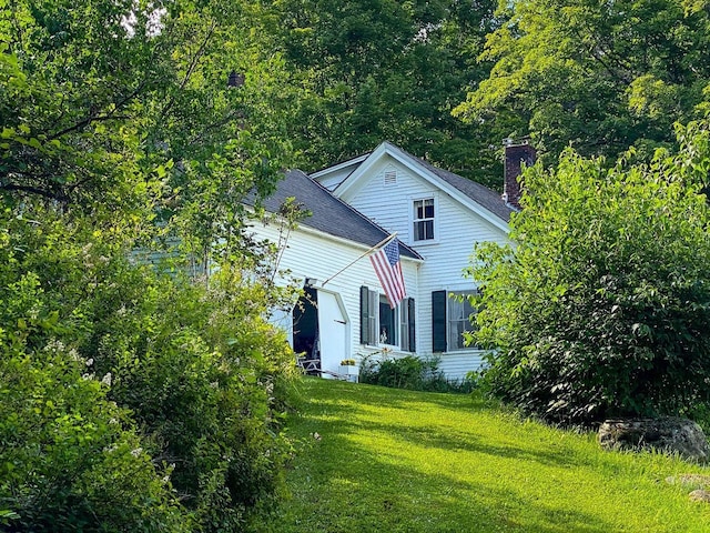 view of home's exterior with a yard