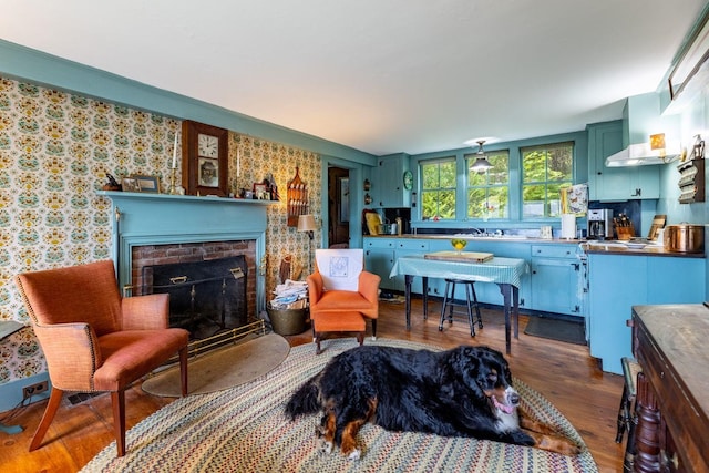 sitting room featuring a fireplace and dark hardwood / wood-style flooring