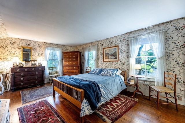 bedroom with multiple windows and hardwood / wood-style floors