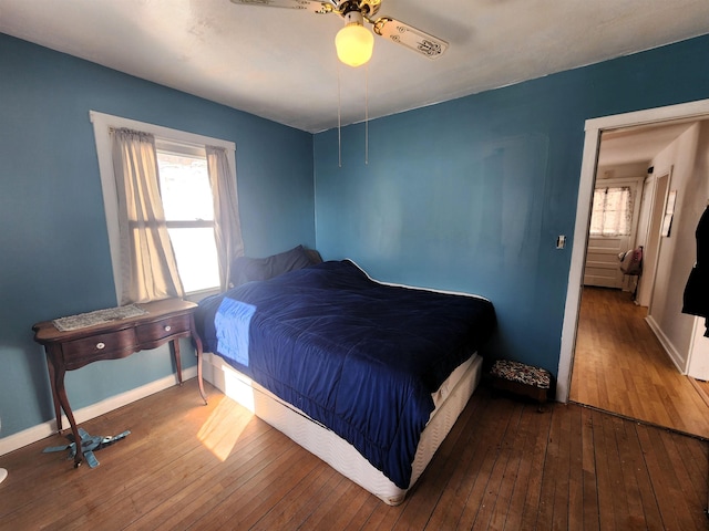 bedroom with hardwood / wood-style floors and ceiling fan