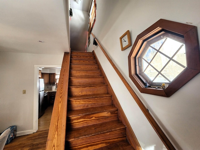 stairway with hardwood / wood-style floors