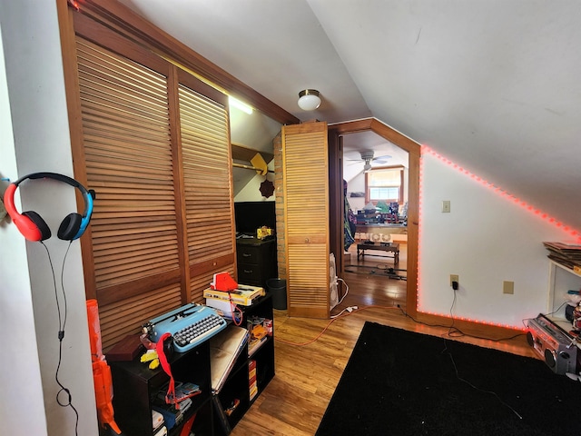 interior space featuring vaulted ceiling, light hardwood / wood-style floors, and ceiling fan