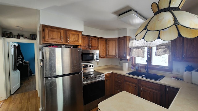 kitchen featuring sink, hardwood / wood-style flooring, and stainless steel appliances