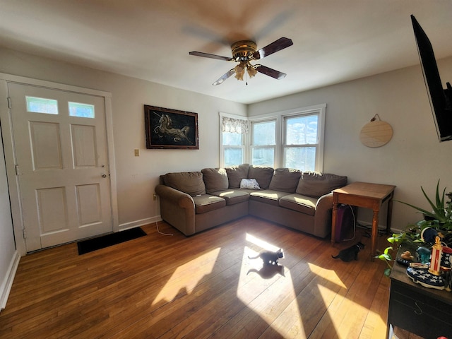 living room with hardwood / wood-style floors and ceiling fan