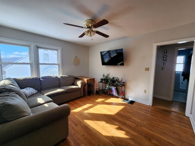 living room featuring hardwood / wood-style flooring and ceiling fan