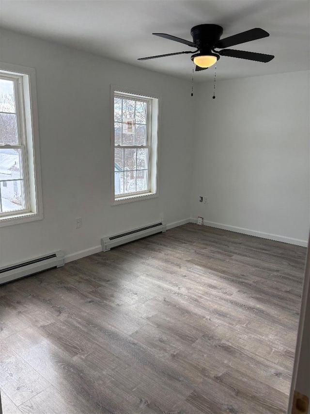 unfurnished room featuring ceiling fan, a baseboard radiator, and light hardwood / wood-style flooring