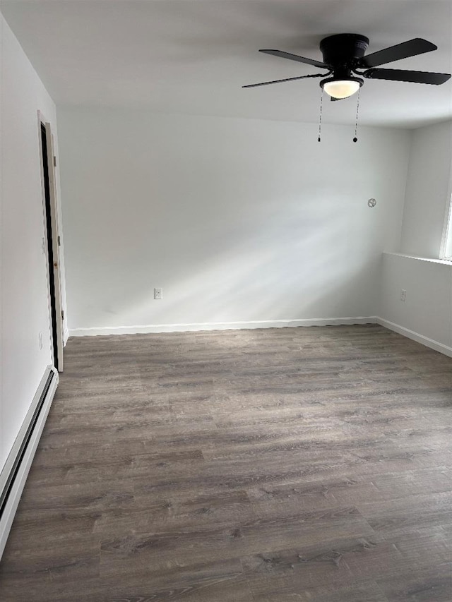 unfurnished room with ceiling fan, a baseboard radiator, and dark hardwood / wood-style flooring