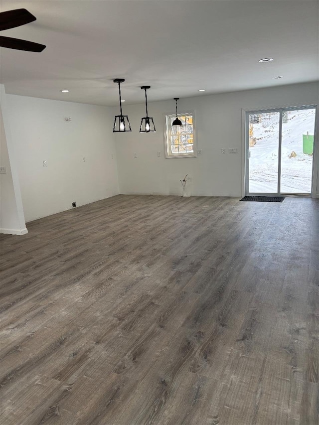 unfurnished room featuring ceiling fan and dark hardwood / wood-style flooring