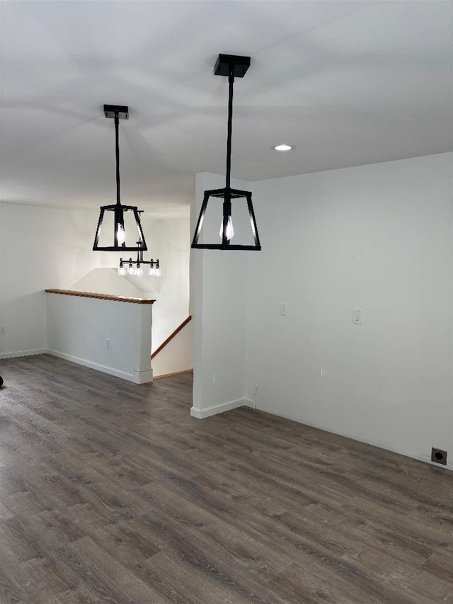 unfurnished dining area with dark wood-type flooring