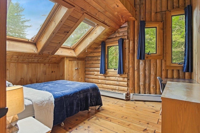 bedroom featuring a baseboard heating unit, light hardwood / wood-style flooring, lofted ceiling with skylight, and rustic walls