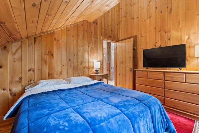 bedroom with wooden walls, vaulted ceiling, and wooden ceiling