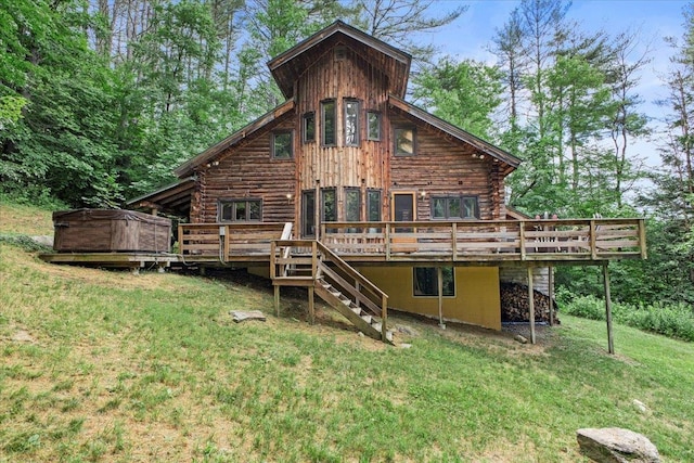 back of house featuring a deck and a lawn