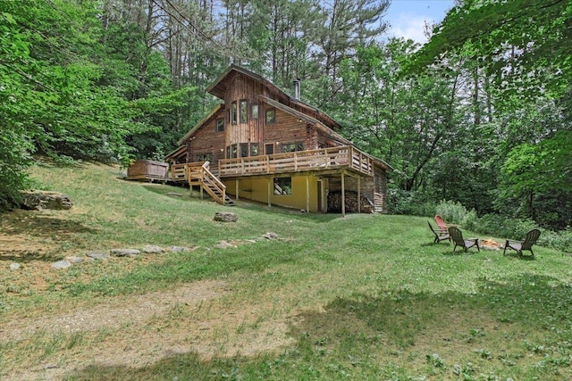 view of yard featuring a deck and an outdoor fire pit