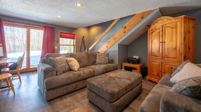 living room with wood-type flooring and a textured ceiling