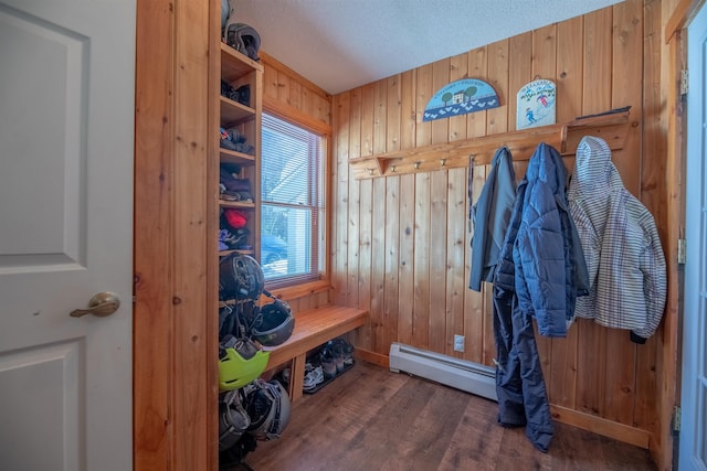 mudroom featuring a baseboard radiator, dark hardwood / wood-style floors, a textured ceiling, and wood walls