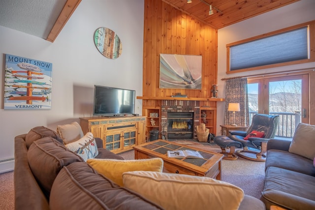 carpeted living room featuring a brick fireplace, track lighting, high vaulted ceiling, and wooden ceiling