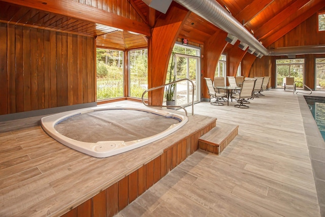 unfurnished sunroom featuring lofted ceiling, wood ceiling, and a jacuzzi