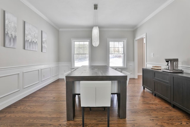 dining area with ornamental molding and dark wood-type flooring