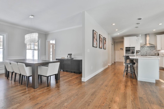 dining room featuring hardwood / wood-style floors, a notable chandelier, and ornamental molding