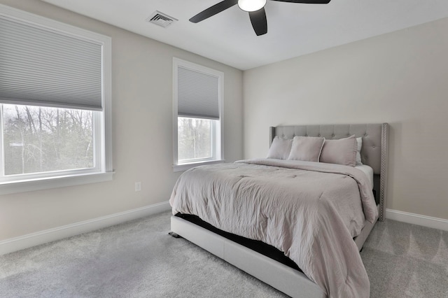 bedroom featuring light colored carpet and ceiling fan