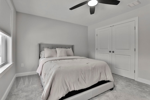 carpeted bedroom with a closet and ceiling fan