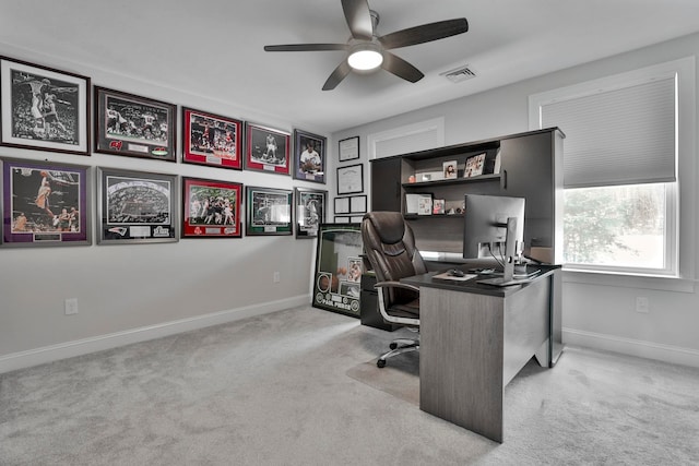 carpeted office space with ceiling fan