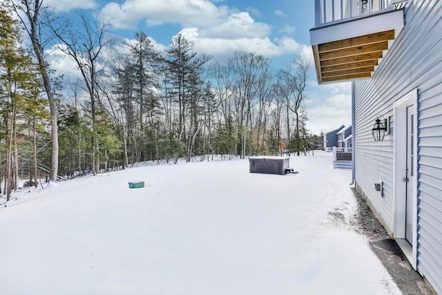 yard covered in snow with a hot tub