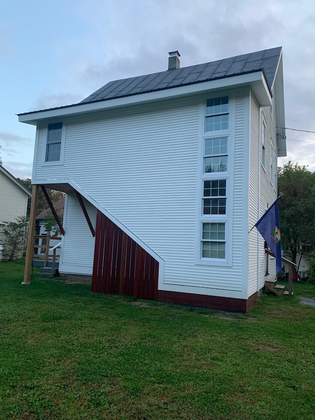 view of side of home featuring a yard