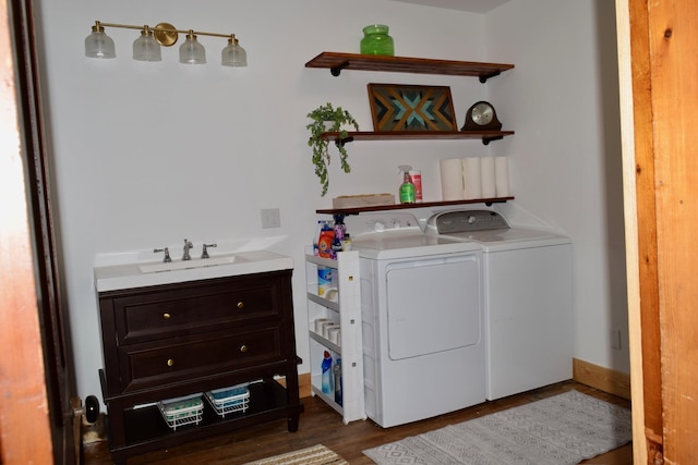 washroom with sink, dark hardwood / wood-style floors, and washer and dryer