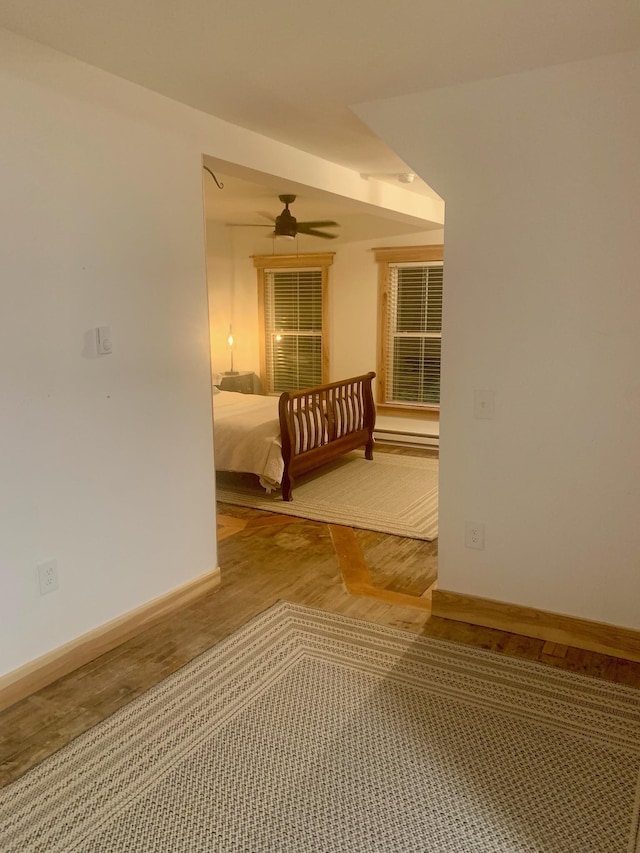 unfurnished bedroom featuring hardwood / wood-style floors and ceiling fan