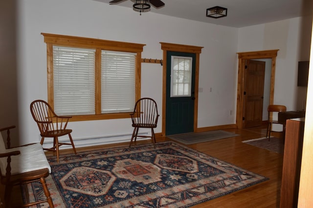 foyer entrance featuring ceiling fan and wood-type flooring